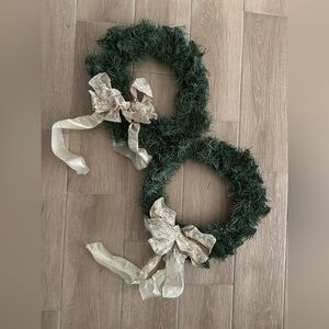 Pair of artificial Christmas wreaths with gold bows